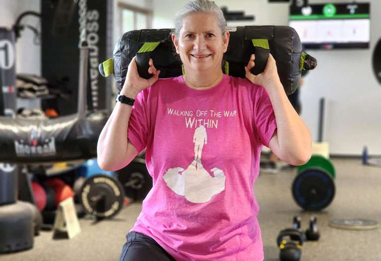 Older female doing weight training