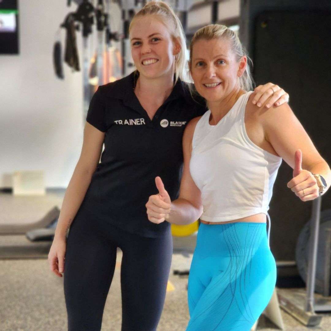 Female Trainer with Happy Female Client